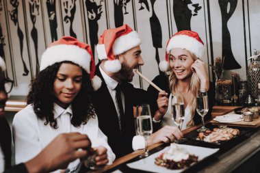 Drink Alcoholic Beverages. Santa's Hat. Girls and Guys. Young People. Rest. Different Races Communicate. Bar. Have Fun. Together. Clubbing. Nightlife. Joyful. Chin-chin. Leisure. Positive. Emotion. clipart