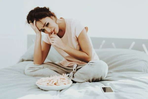 孤独な泣いている女性は ベッドの上のフライド ポテトを食べる 不幸な休日 悲しい週末 顔に涙 晴れた日 寝室で一人で 失望した女の子 甘やかされて育った化粧 — ストック写真