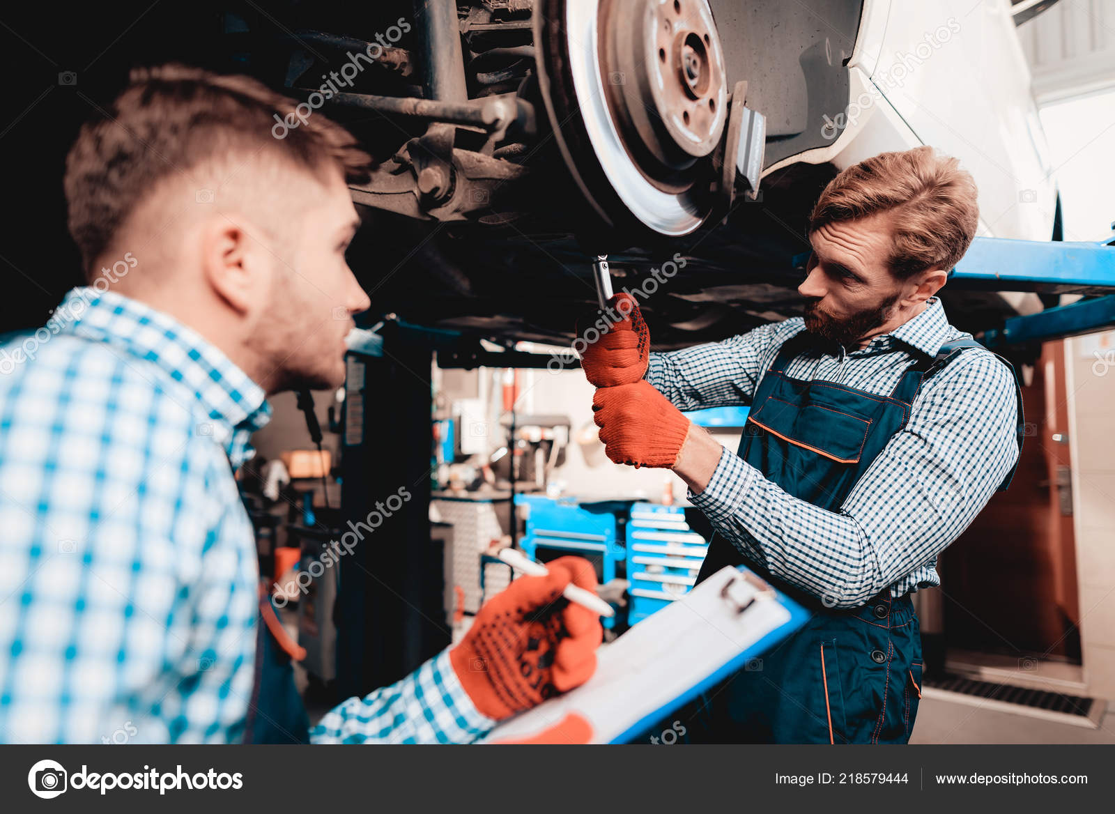 Young Mechanic Repairs Automotive Hub Garage Professional Uniform