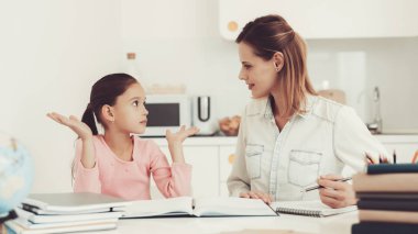 Anne kızı mutfakta ödev yapmak için yardımcı olur. Aile ilişki kavramı. Eğitim çocukluk. Evde eğitim. Bilgi alma. Bilgi yazma. Ebeveynler görev. Birlikte çalışma.