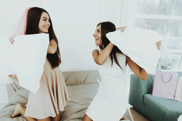 Girls Pillow Fight On A Pre-wedding Hen-party. Beautiful Shiny Smile. Resting With Bride. Sunny Day. Good Mood. Young And Attractive. Happy Holiday. Long Hair. Pre-wedding Fun Concept.