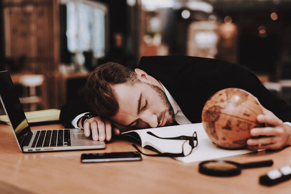 Business Suit. Sleeping in Workplace. Creative Worker. Globe. Project. Laptop. Young Guy. Businessman. Office. Ideas. Businesspeople. Workplace. Inspiration. Relaxation. Hobby. Comfortable Office.