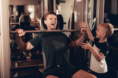 Baba-halter kaldırma sırasında oğlu destek. Ebeveynlik ilişki. Sportif aile kavramı. Aktif yaşam tarzı. Mutlu çocukluk. Holiday Leisure. Birlikte çalışma dışarı. Fitness gün.