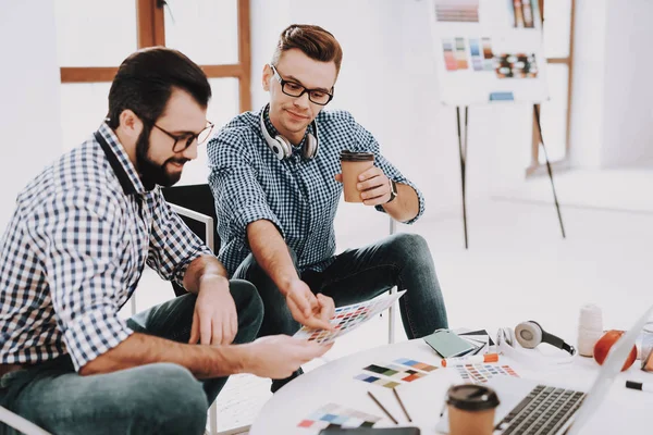 Brainstorming. Choose Colors for Design. Men. Work Together. Office. Designers. Teamwork. Discussion. Partnership. Design Studio. Multi-Ethnic. Project. Creative. Workplace. Laptop. Paper Cup.