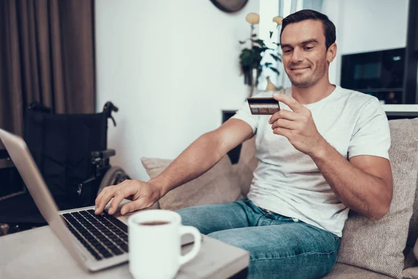 Disabled Person Holds Credit Card Uses Laptop Handsome Young Smiling — Stock Photo, Image