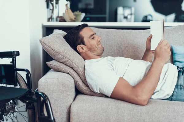 Hombre Acostado Sofá Con Tableta Cerca Silla Ruedas Alegre Guapo — Foto de Stock