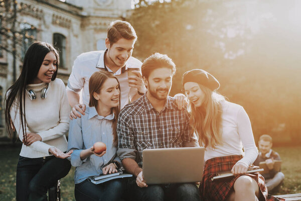 Have Fun. Notebooks. Friendship. Knowledge. Architecture. Freelance. Hipster. Group of Young People. Sit. Courtyard. University. Students. Study Together. Good Mood. Laptop. Textbooks.