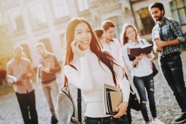 Telefon. Mutlu. İyi bir ruh hali. Üniversitesi. Bilgi. Avlu. Kitaplar. Mimarisi. Mutluluk. Asyalı kız. İstihbarat. Diploma. Ayakta. Üniversitesi. Kutlama. Kampüs. Adam arkadaş. Öğrenciler.