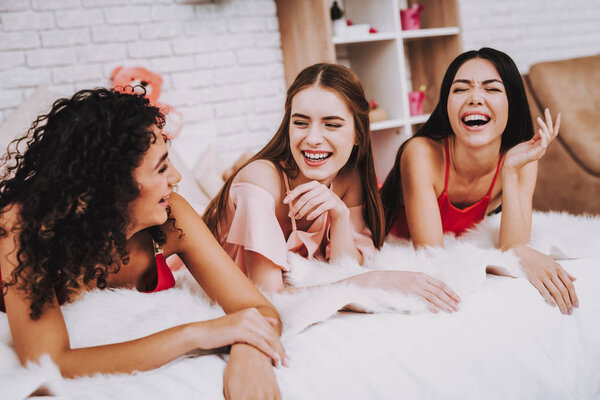Girl Lying on Bed. Celebrating Women's Day. Emotional Women. Beautiful Girl. Meeting Girlfriends. White Interior. International Women. Happy Womens Day. Red Dress. Smiling Women on Bed. Happy Face.