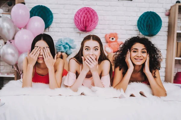 Lying on Bed. Celebrating Women\'s Day. Emotional Women. Bed with White Plaid. White Interior. International Women. Happy Womens Day. Smiling Women on Bed. Happy Face. Covering Eyes. Pink Baloon.