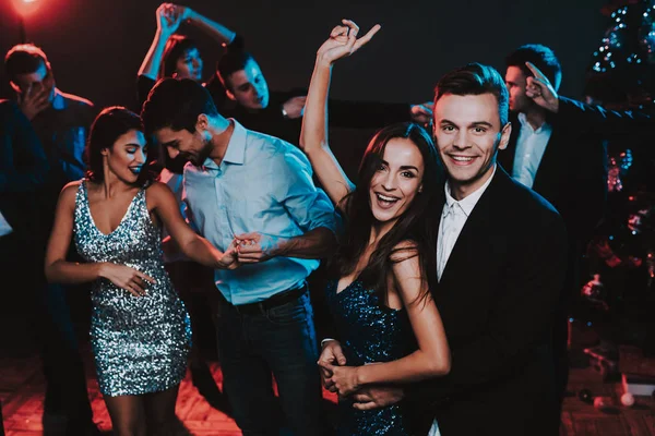 Happy Young People Dancing on New Year Party. Happy New Year. People Have Fun. Indoor Party. Celebrating of New Year. Young Woman in Dress. Young Man in Suit. Happy People. Modern Dances.