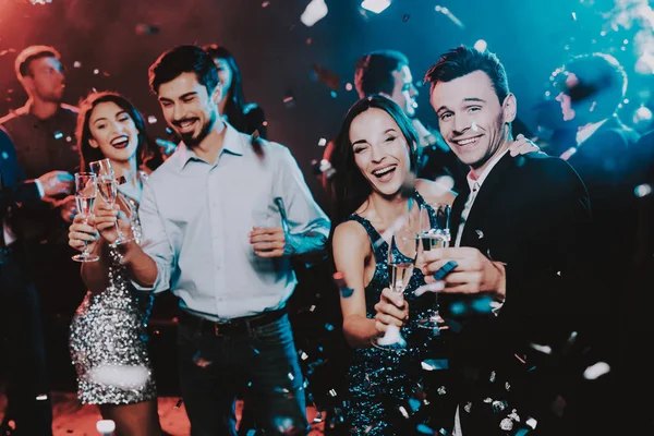 Happy Young People Dancing on New Year Party. Happy New Year Concept. Glass of Champagne. Celebrating of New Year. Young Woman in Dress. Young Man in Suit. Happy People. Modern Dances.