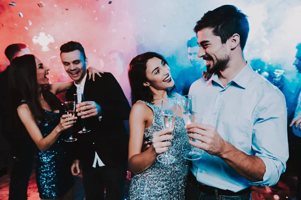 Happy Young People Dancing on New Year Party. Happy New Year Concept. Glass of Champagne. Celebrating of New Year. Young Woman in Dress. Young Man in Suit. Happy People. Modern Dances.