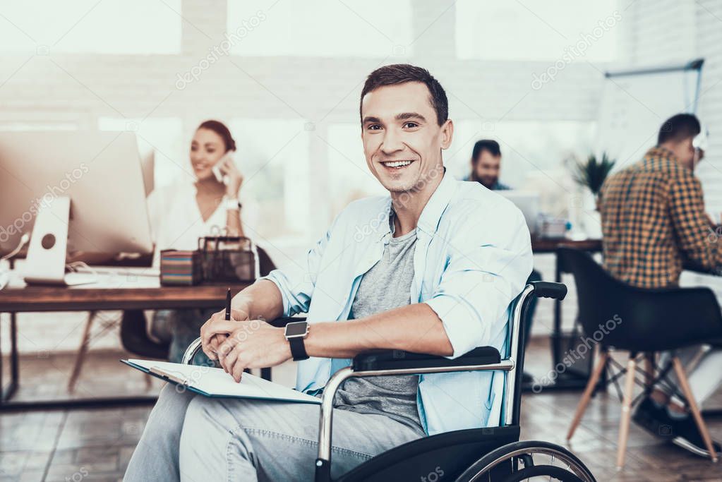Disabled Man on Wheelchair with Tablet in Office. Teamwork in Office. Young Worker. Sitting Man. Disabled Young Man. Man on Wheelchair. Recovery and Healthcare Concepts. Guy in Office.