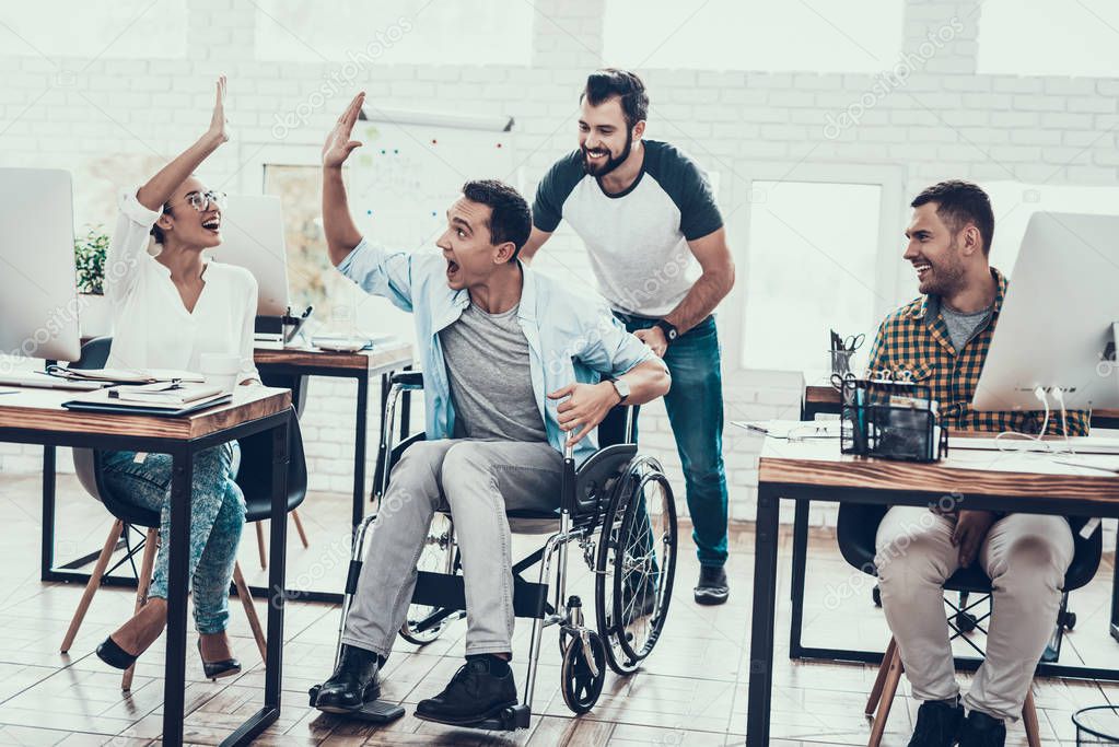Happy Workers Have Fun on Break in Modern Office. Smiling Woman. Man on Wheelchair. Smiling Manager. Communication with Colleagues. Fun in Office. Teamwork Concept. Manager in Office.