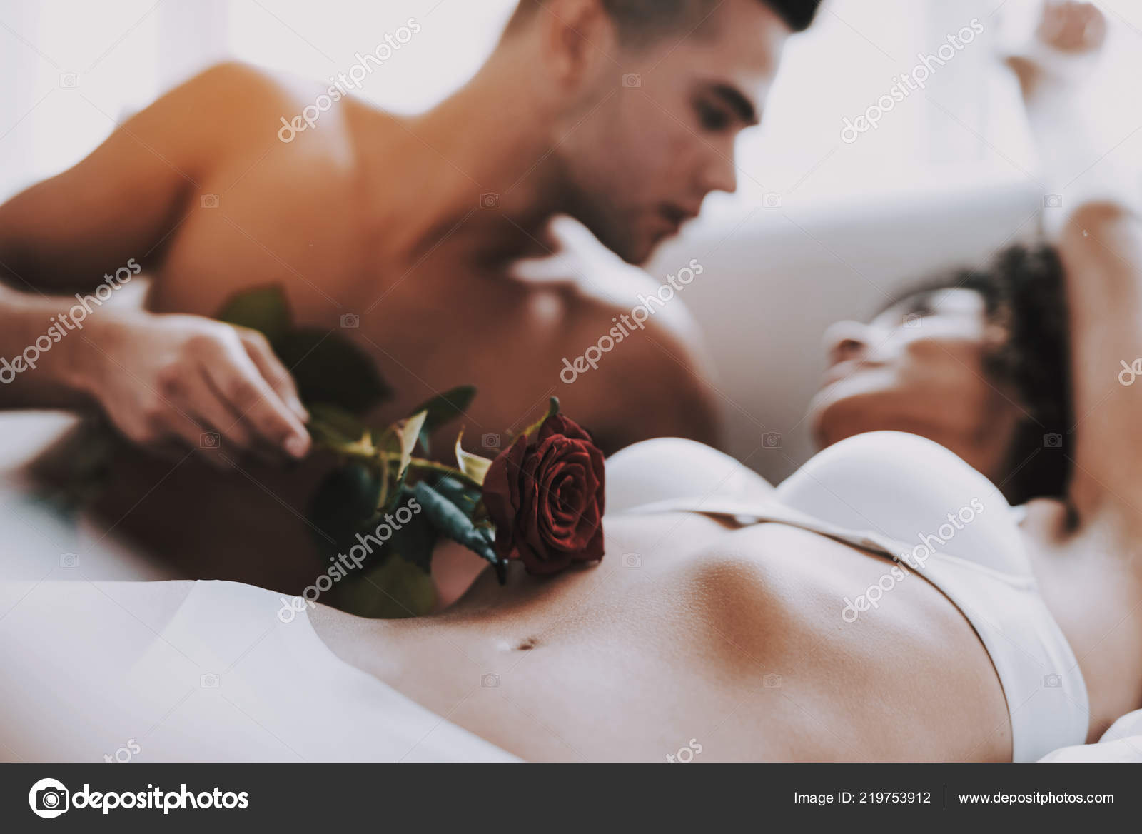 Closeup Man Caresses Beautiful Woman Using Rose Young Beautiful Couple Stock Photo by ©vadimphoto1@gmail 219753912