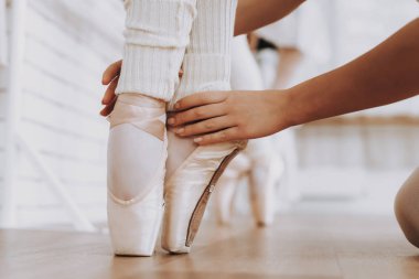 Yakın çekim. Bale eğitimi genç kızların kapalı. Klasik bale. Kız balerin Tutu. Kapalı eğitim. Şirin dansçılar. Performans salonunda. Pratik dans. Kızlar beyaz elbiseler.