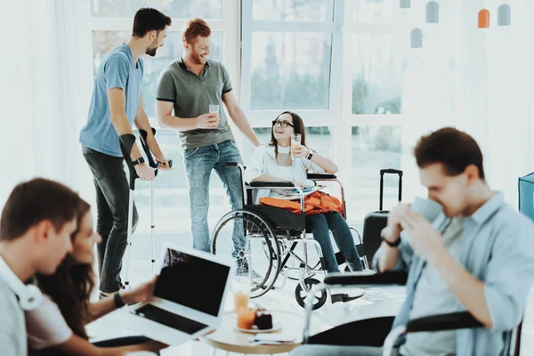 People in Wheelchair. Disabled in Hall. Woman in Wheelchair. Man on Crutches. Disabled Hall Airport. Room with Panoramic View. White Interior. Limited Opportunities. Woman with Glasses Juice.