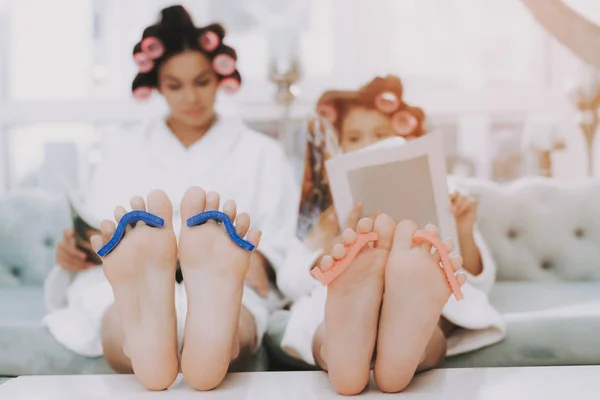 Spa Day in Beauty Salon. Little Lady with Curlers. Mother and Daughter in Spa. Consept Beauty Salon. Beautiful Face. Woman and Happy Child. Woman with Curlers. Doing Selfie. Blue Sofa in Spa Salon.