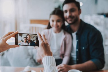 Çay saati. Restoran. Baba ve kızı. Smartphone. Gülümseyen insanlar. Genç aile. Mutlu birlikte. İyi bir ilişki. Cafe. Aile tatili. Etkin boş zaman. Şirin ilişki. Kutlama.