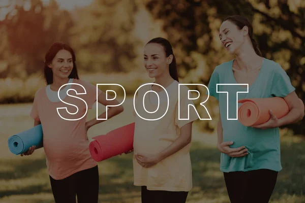 Sport. Have Fun. Talk. Three Girls. Pregnant. Smiling. Yoga Mats. T-shirt. Walk. Park. Beautiful. Belly. Bodycare. Crossfit. Exercise. Happiness. Healthy Lifestyle. Mom. Nature. Sportswear.