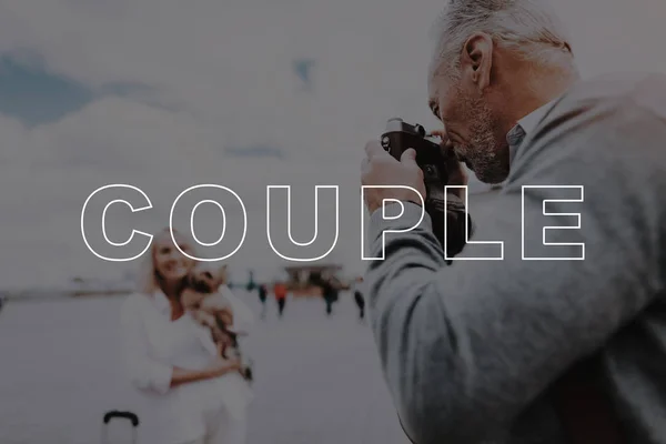 Film Camera. Poses. Takes Pictures. Love Story. Travel Bag. Interesting Trip. Little Dog. Sweet Moments. Happy Together. Old Couple. Two Pensioners. Walk. Square. Retired. Leisure Time. Have Fun.