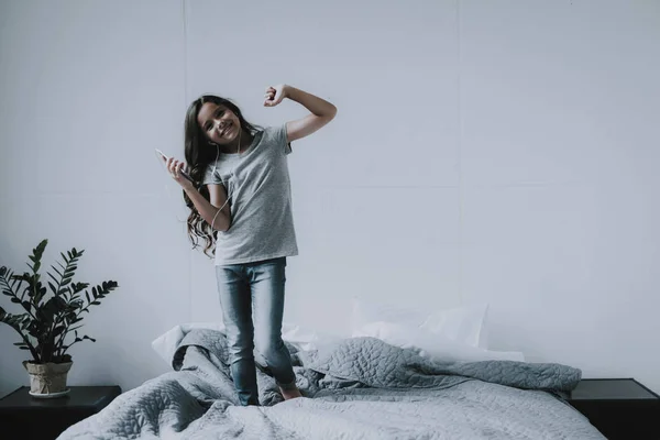 Sevimli Küçük Kız Yatakta Smartphone Ile Dans Müzik Dinler Neşeli — Stok fotoğraf
