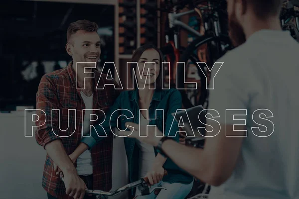 Family Purchases. Customers Choosing a Bicycle. Salesman Showing Bicycle to Customers. Customers is Couple of Man and Woman. Woman Using a Bicycle. Customers are Happy and Smiling. Bicycle Shop.