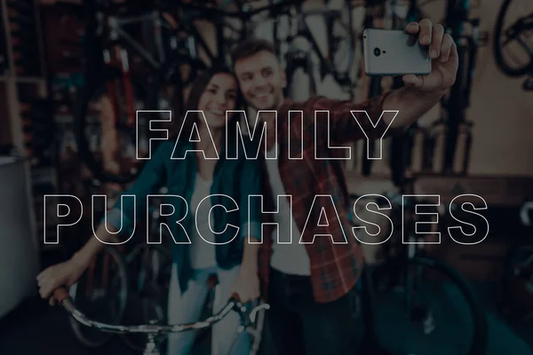 Family Purchases. Customers Choosing a Bicycle for Himself. Customers is Couple of Man and Woman. Couple Doing Selfie on Smartphone. Woman Sitting on Bicycle. People Happy and Smiling. Bicycle Shop.