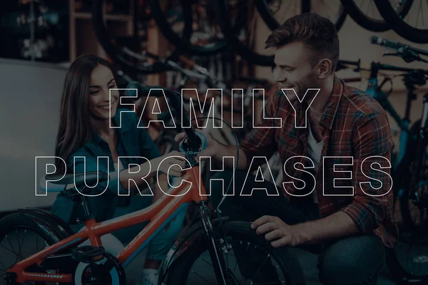 Family Purchases. Customers Choosing a Bicycle for Himself. Customers is Couple of Man and Woman. Customers Looking on Bike. Bike for Little Children. Couple Happy and Smiling. Bicycle Shop.