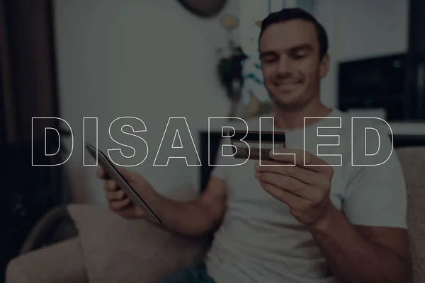 Disabled Man Man Sitting Sofa Wheelchair Background Man Man Holding — Stock Photo, Image