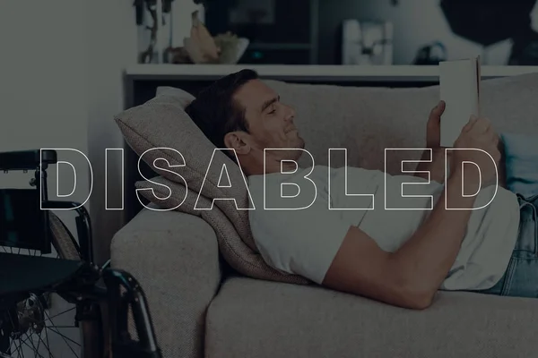 Disabled Man Man Lying Sofa Wheelchair Background Man Man Reading — Stock Photo, Image