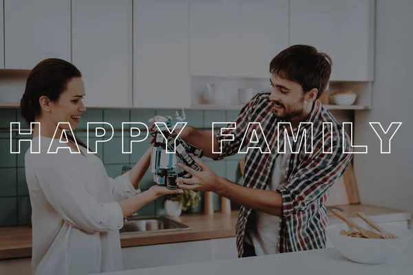 Happy. Leisure Time. Salad. Young Couple. Kitchen. Bubbly Relationships. Help. Guy. Work Together. Man. Robot. Girl. Smiling. Beautiful. Have Fun. Family. Designing Robots. Home. Happiness.