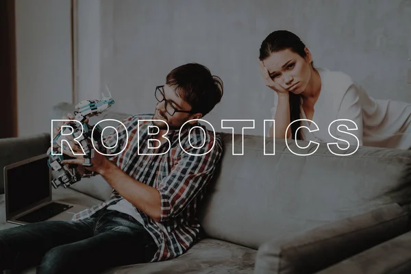 Ignores. Unhappy. Play. Couch. Hugs. Living Room. Young Couple. Collect. Robots. Guy. Work Together. Girl. Smiling. Beautiful. Leisure Time. Have Fun. Family. Designing Robots. Home. Happiness.