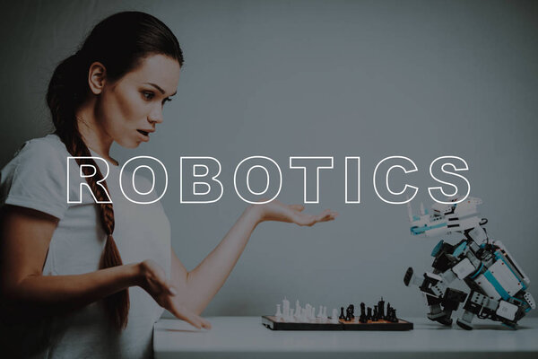 Beat. Surprised. Chessboard. Woman's Hand. Play. Move. Small. Robot. Stand. Design. Digital. Happiness. Happy. Home. House. Interior. Machine. Relationship. Technology. Mechanical. Innovation. Smile.