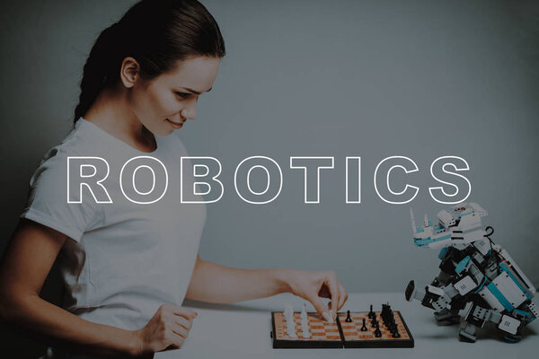 Play. Move. Chessboard. Woman's Hand. Small. Close Up. Robot. Stand. Design. Digital. Happiness. Happy. Home. House. Interior. Machine. Relationship. Technology. Mechanical. Innovation.