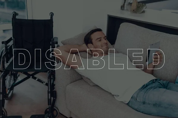 Disabled Man Man Lying Sofa Wheelchair Background Man Man Watching — Stock Photo, Image