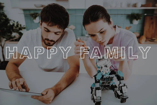 Work Together. Help. Guy. Bubbly Relationships. Man. Collect. Robot. Kitchen. Girl. Hugs. Smiling. Beautiful. Pink Robe. Happy. Leisure Time. Have Fun. Family. Designing Robots. Home. Happiness.