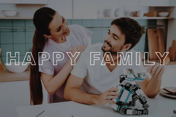 Bubbly Relationships. Man. Collect. Robot. Kitchen. Girl. Hugs. Smiling. Beautiful. Pink Robe. Happy Together. Leisure Time. Have Fun. Family. Designing Robots. Home. Spare-Time. Off-Time. Happiness.