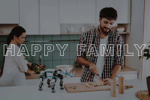 Cooking. Busy. Focused. Robot. Leisure Time. Designing Robots. Happy. Young Couple. Kitchen. Relationships. Help. Guy. Work Together. Man. Girl. Smiling. Beautiful. Have Fun. Family. Home. Happiness.