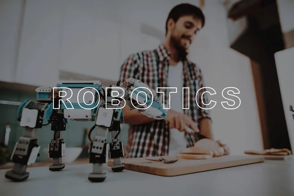 Cut. Bread. Sandwiches. Cooking. Busy. Focused. Robot. Leisure Time. Designing Robots. Happy. Young. Kitchen. Relationships. Help. Guy. Man. Smiling. Beautiful. Have Fun. Family. Home. Happiness.