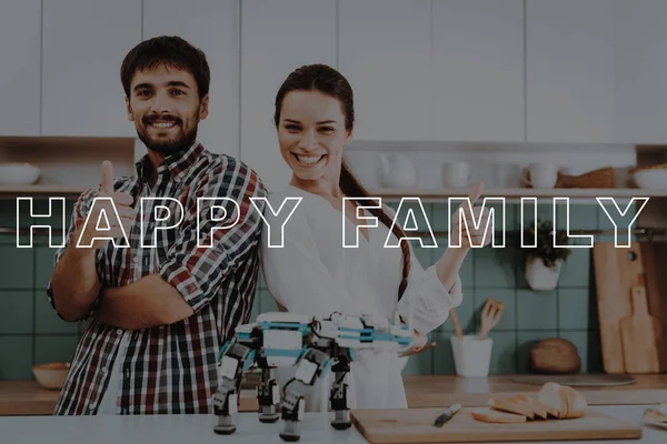 Posing. Cooking. Busy. Focused. Robot. Leisure Time. Designing Robots. Happy. Young Couple. Kitchen. Relationships. Help. Guy. Work Together. Man. Girl. Smiling. Have Fun. Family. Home. Happiness.