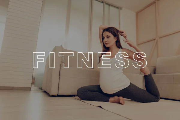 Yoga at Home. Exercises. Warm-up Legs. Stretch. Pregnant Sport. Woman. Light Floor. Home. Position. Care for Child. Good Health. Relax. Fitness. Anticipation. Smiles. Daily Life. Mom. Love. Prenatal.