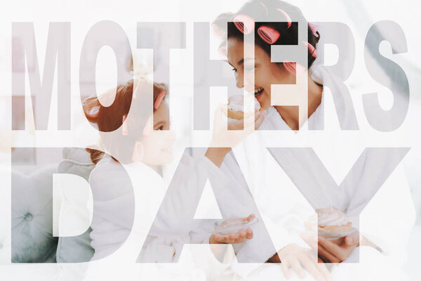 Family in White Bathrobes. Women have Curlers in their Hair. Mother and Daughter Have Fun. Kid Express their Joyful Emotions. Daughter Spend Good Time. Daughter is Feeding her Mother a Cake.