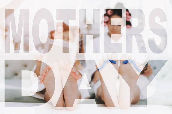 Close up Photo. Family with Sponge for Pedicure on Fingers. Mother and Daughter read Magazines in Bathrobes. Women have Curlers in Hair. Daughter Spend Good Time. Happy Family Have Fun.