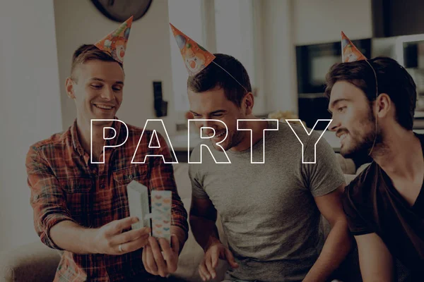 Present. Happy Birthday. Men. Put On. Birthday Hat. Prepar Party. Guys. Sit on Couch. Best Friend Forever. Happy Together. Celebration. Gifts. Having Fun. Spend Time Together. Cheerful. Surprise.