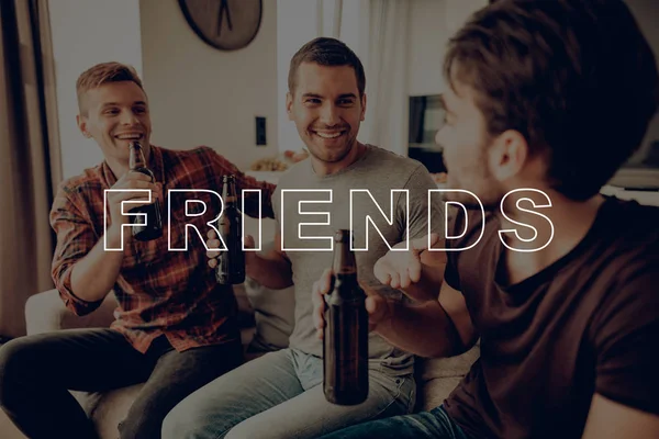 Happy Together. Talk. Three Men. Drink Beer. Dark Bottles. Sit on Couch. Smiling. Posing for Photo. Party. Guys. Best Friend Forever. Celebration. Friend. Having Fun. Spend Time Together. Cheerful.