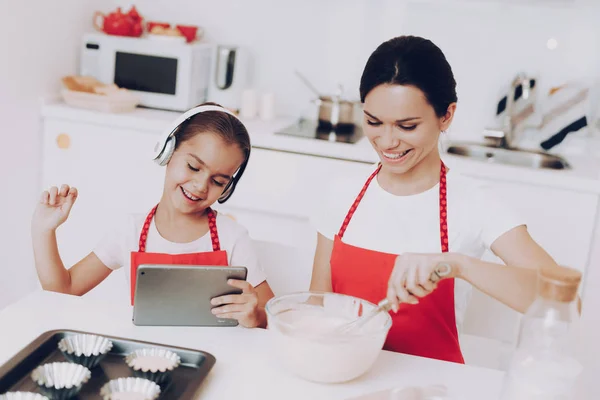 Childhood for Little Girl. Cake Molds for Good Pie and Biscuit. Two Woman Cook Food. Mom Help Daughter with Sweet Breakfast. Fun Girl spend Time with Beautiful Mom. Cook with Mom and Young Daughter.