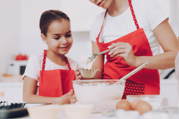 Mom and Girl Cook in Kitchen. Little Girl with Young Mother. Joi Kid with Mom Preparation Breakfast for all Family. Childhood with Mom in the Kitchen. Love Day Little Girl with Mom. Parent and Girl.