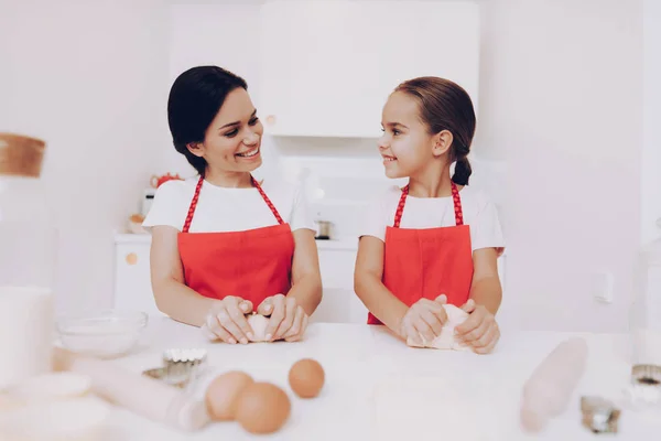 Smile with Girl. Mom Help Daughter with Cook. Joy Kid with Mom Happy Time Together. Family in the Kitchen. Love Time with Family. Preparation in the Cook. Beautiful Mom Help Young Daughter with Cook.